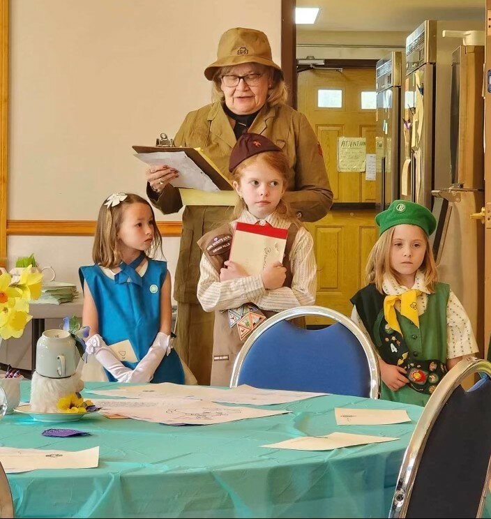 Zoe Wood, Addy VanTyle and Jana Ballard are dressed in vintage Girl Scout uniforms for a fashion show held Saturday, April 27. Also pictured in Girl Scout Leader Lynn Hoover.
